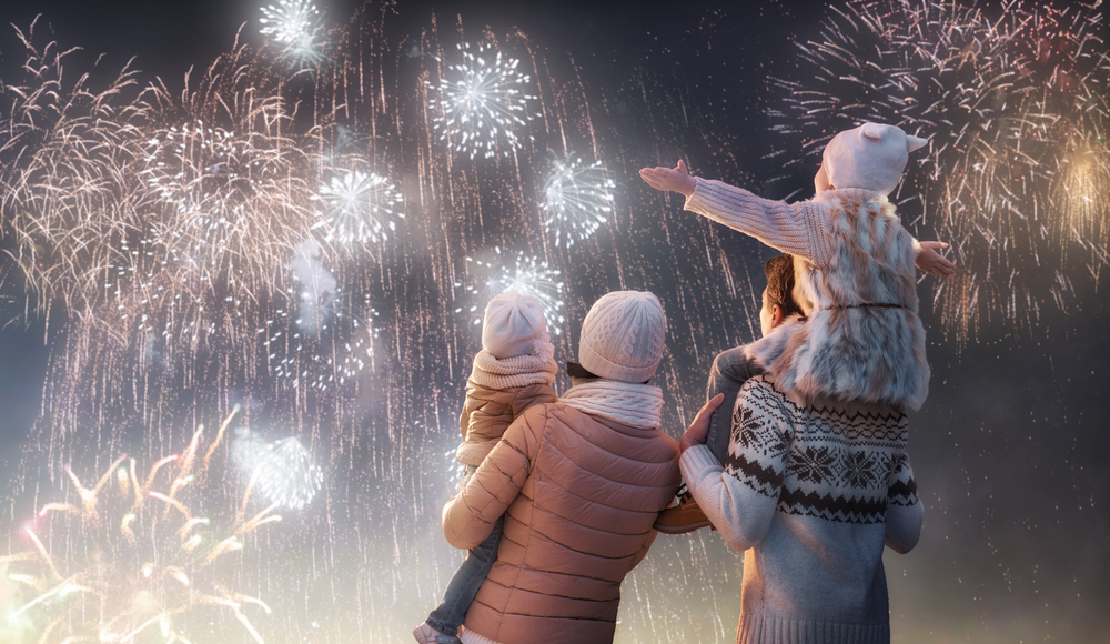 family-watching-fireworks-in-sky