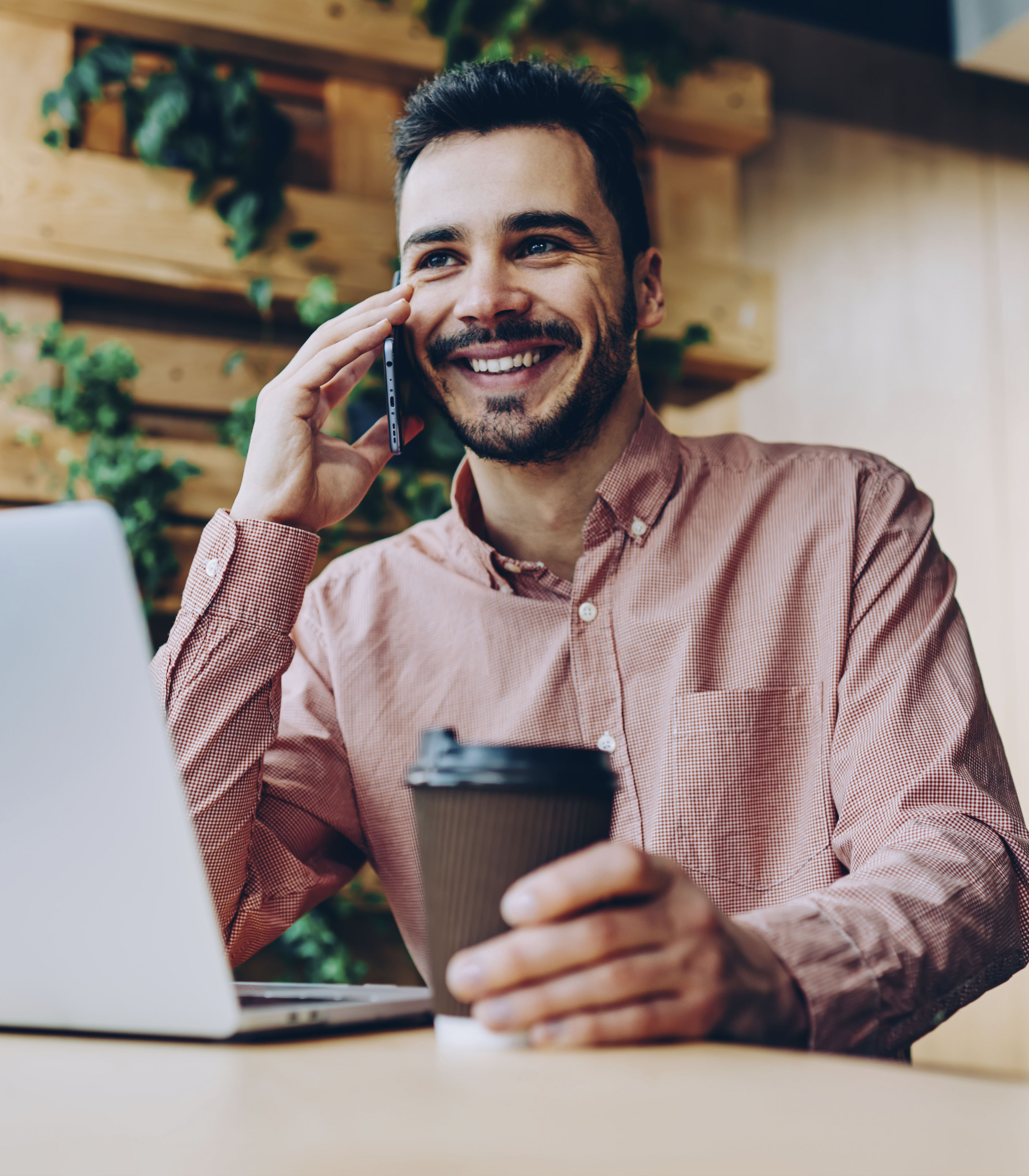 Guy on phone with coffee